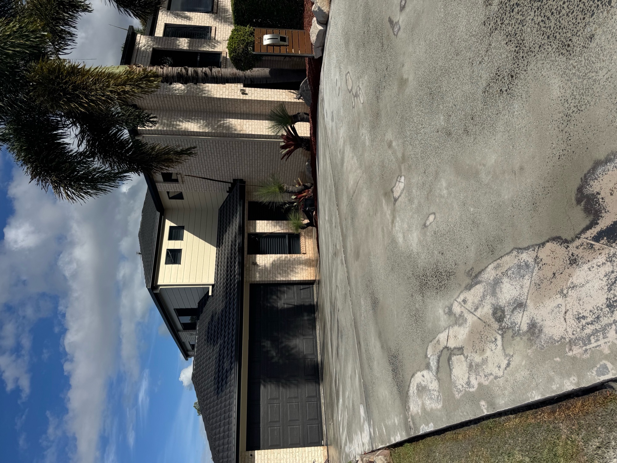 Driveway before covercrete resurfacing in Midnight Blue with white stencil